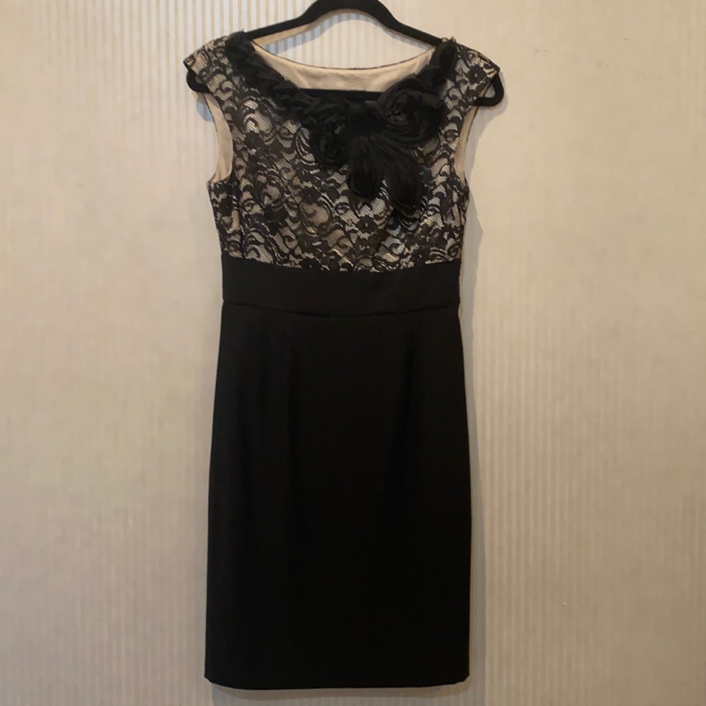 Black lace dress with floral decals around neck